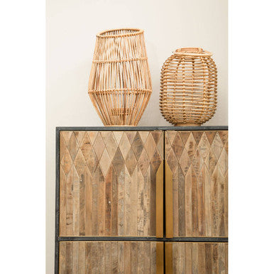 Two woven natural rattan lanterns with a tall natural rattan slender vase and a shorter rounder vase in natural color