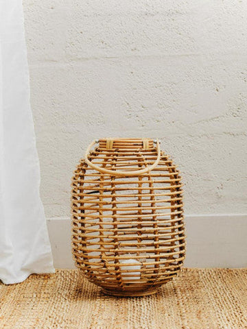Mataram tall natural rattan lantern in natural woven rattan with sturdy handle and oval shape for cozy lighting