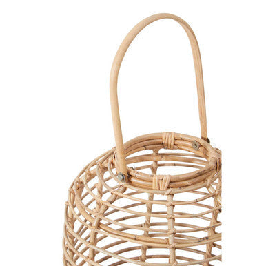 Tall natural rattan lantern matarams features a curved handle and natural woven rattan design in a warm tone