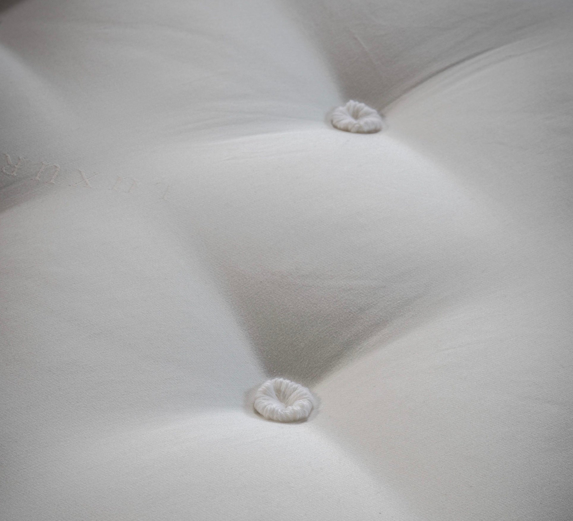White tufted fabric with plush texture and subtle stitching on mattress luxury 4000 springs showing item width depth height