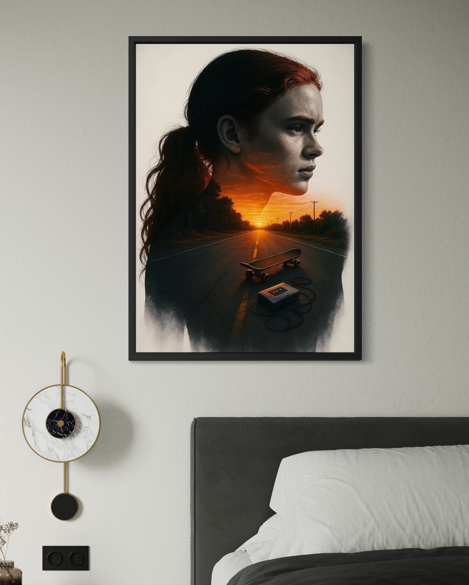 A stranger things poster framed with a red haired woman silhouette over an orange sunset road with skateboard and cassette tape