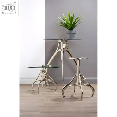 Silver glass tripod tables with industrial metal legs featuring maxi crank mechanism adjustable height design