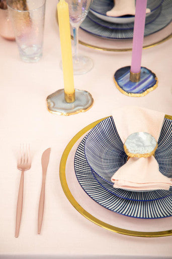 Navy blue and gold striped ceramic plate with gold rim under a blush pink napkin from maya white dinner set