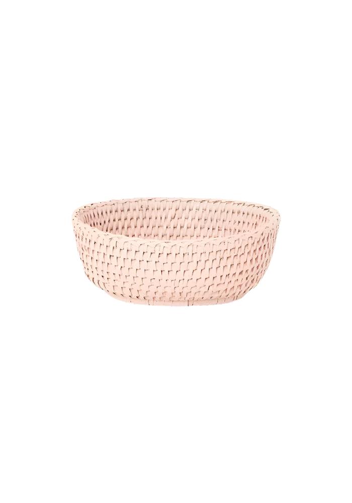 A blush pink mayfair trinket hold all rattan basket with a tight woven weave and rounded edges