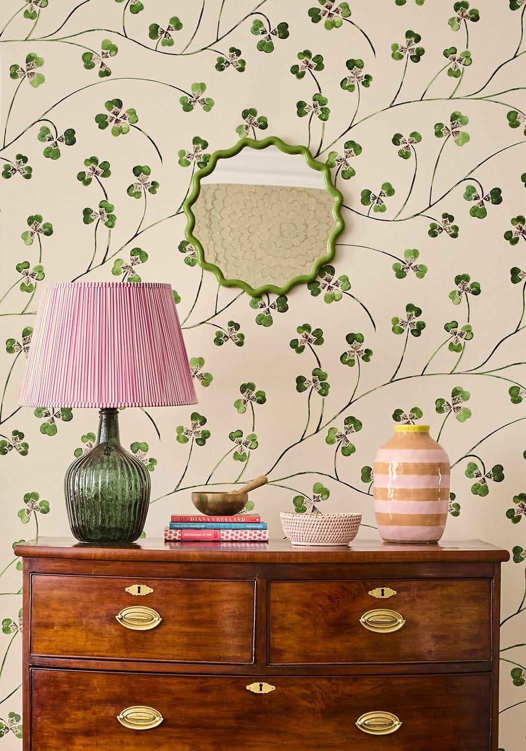 Mayfair trinket hold all rattan basket in pink with a pink pleated lampshade on a textured green glass base