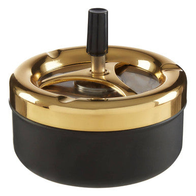 Medium gold and matte black spinning ashtray with a central rotating mechanism for easy ash disposal