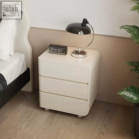 Cream-colored minimalist meg bedside table with three rounded-edge drawers perfect as a sleek bedside table