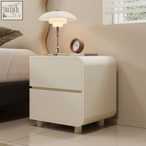 Cream-colored meg bedside table with two smooth drawers and rounded edges for modern bedroom storage