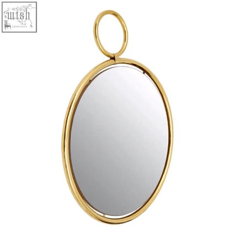 Meissa gold finish pendant wall mirror with gold-toned oval shape and polished metal frame with circular hanging loop