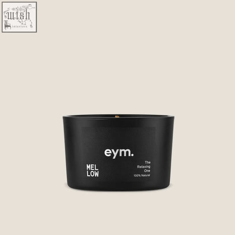 Black cylindrical mini candle in a matte container with simple white label from mellow collection
