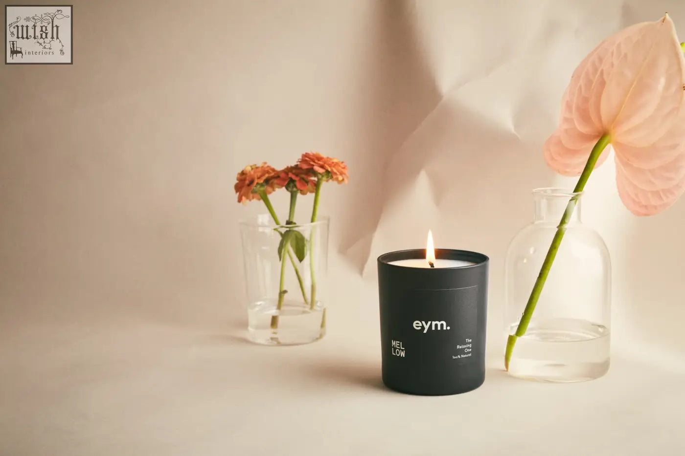 Black cylindrical standard candle with white eym mellow text on matte surface for a mellow vibe