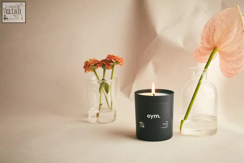 Black cylindrical standard candle with white eym mellow text on matte surface for a mellow vibe