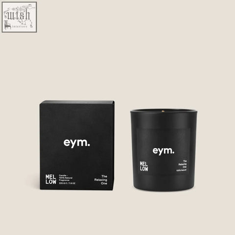Black matte glass standard candle jar with white minimalist branding and wick next to its matching box mellow standard candle