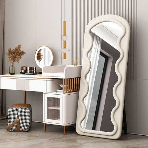 Melody full length mirror with a tall cream-colored frame and wavy padded design perfect for any room