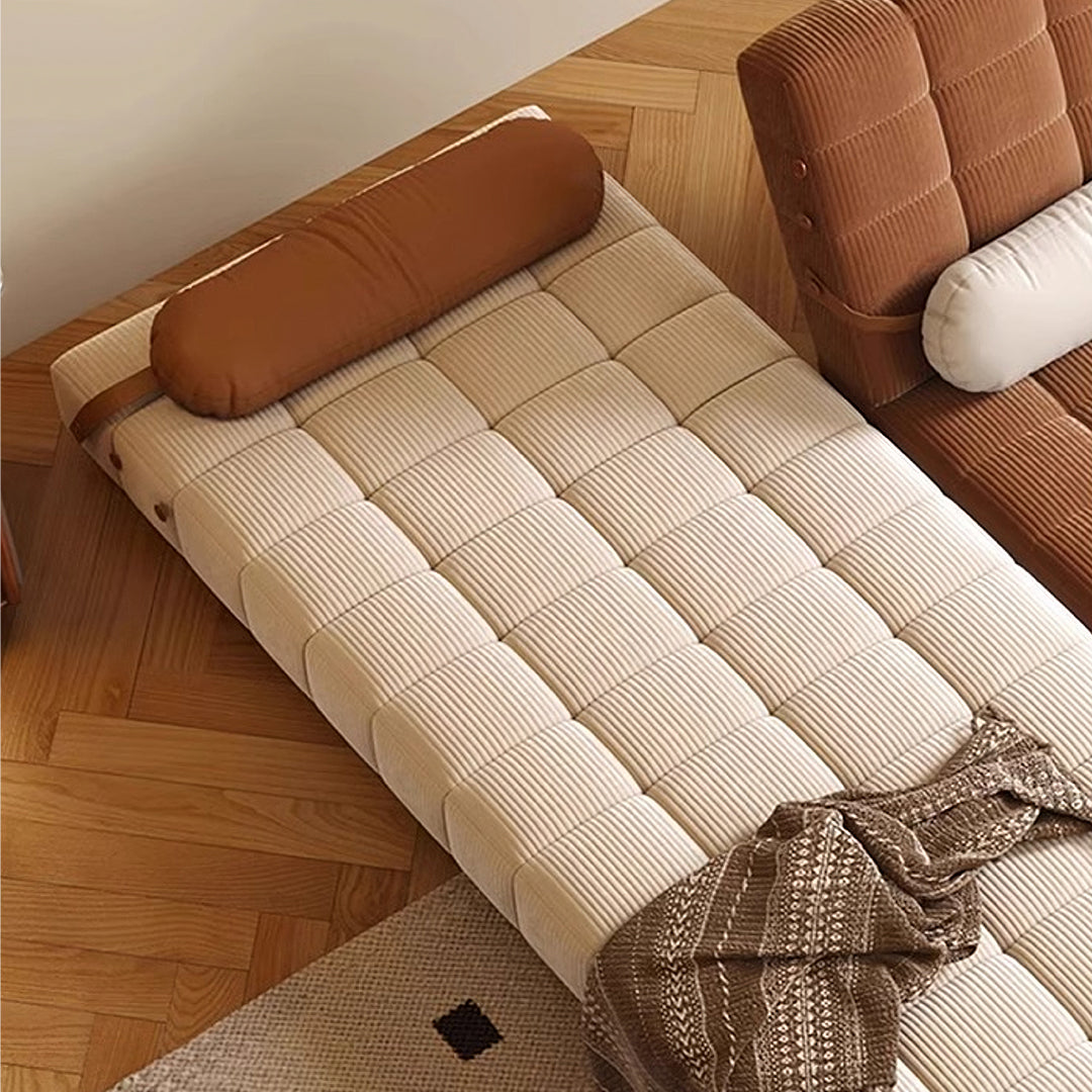 Beige corduroy mendez single sofa bed with quilted square panels and matching brown cylindrical pillow