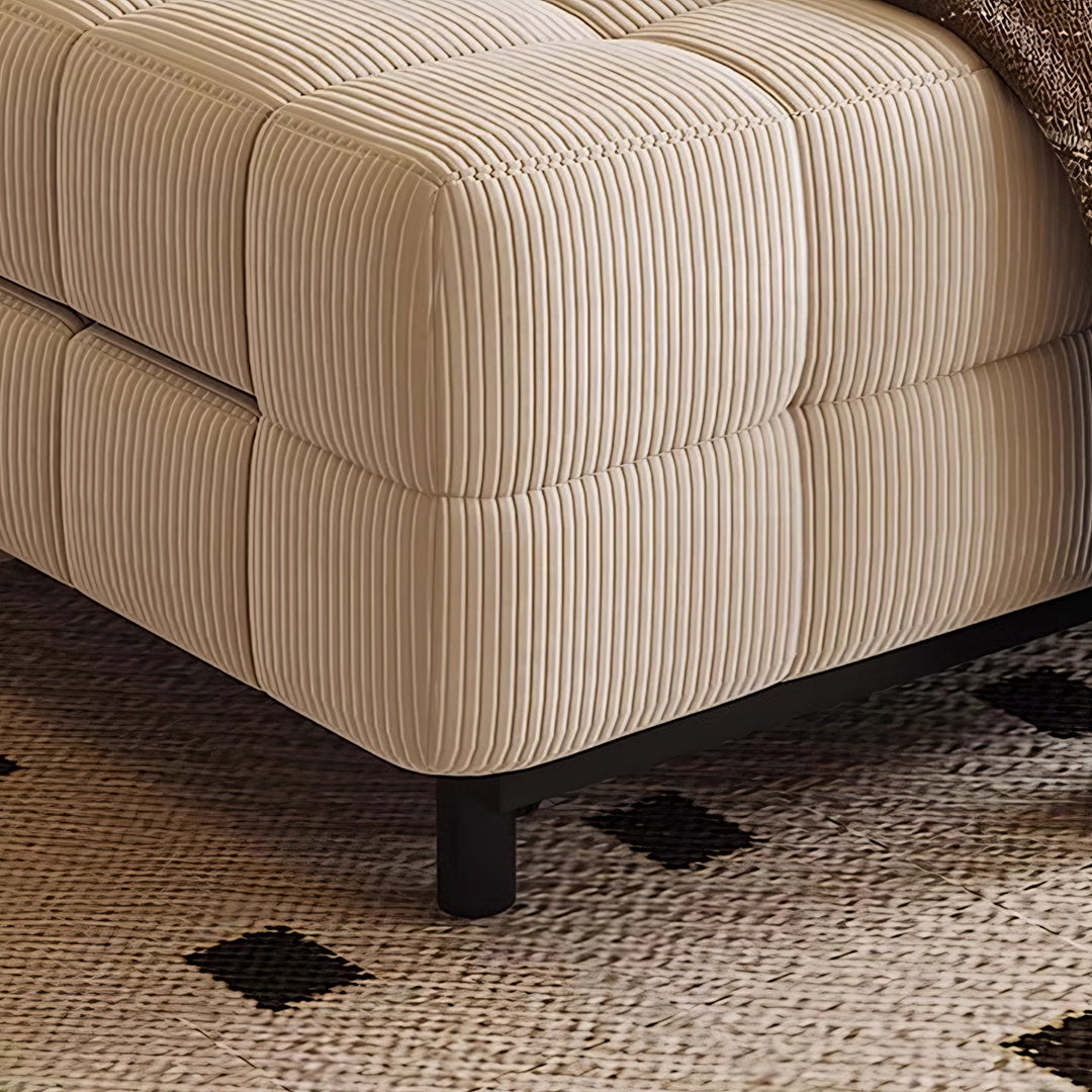 Cream-colored corduroy ottoman with tufted ribbed upholstery and black metal legs for mendez sofa bed
