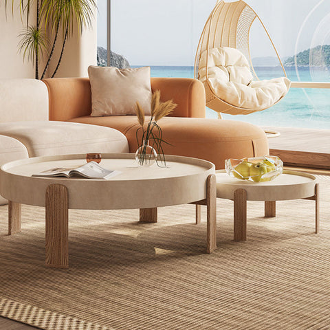 Beige round merle nesting coffee table with wooden legs and minimalist design perfect for small spaces
