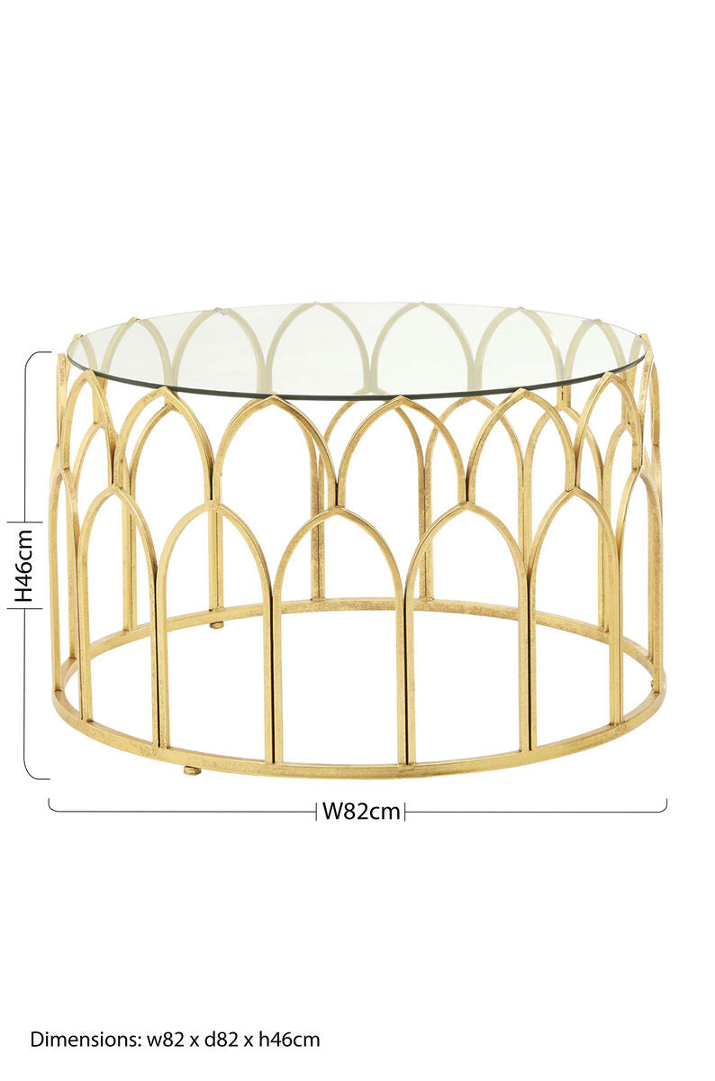 Merlin gold leaf coffee table with gold toned metal frame and clear glass top featuring an arched cage like base