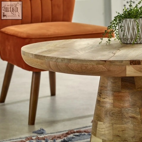 Merlin mango wooden round coffee table with a natural finish and stacked wood panel base in mushroom style