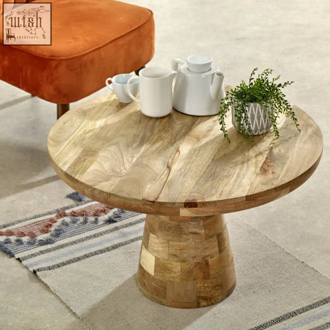 Merlin mango wooden round coffee table with natural finish and stacked wood base in mushroom style
