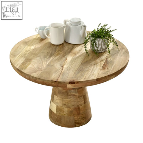 Merlin mango wooden round coffee table with natural finish and mosaic-style pedestal base in mushroom style