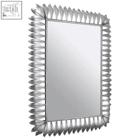 Merlin silver leaf frame wall mirror with a silver-framed rectangular design and decorative spiky leaf frame border
