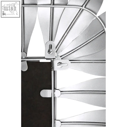 Silver metallic spiral staircase railing with white safety clips highlighting the silver leaf frame wall mirror design
