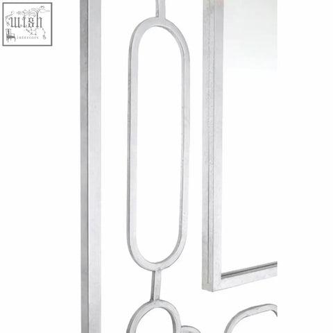 Merlin silver leaf wall mirror with silver-toned metal frame featuring elegant elongated oval and circular geometric design