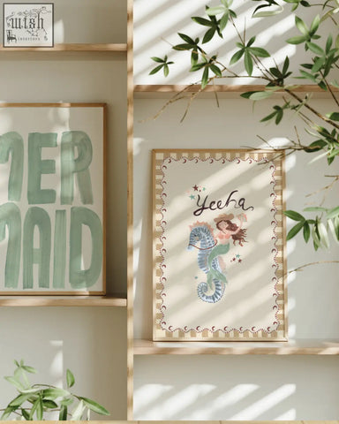 A framed mermaid word art print with a whimsical mermaid riding a seahorse in acrylic paint cream sea collection