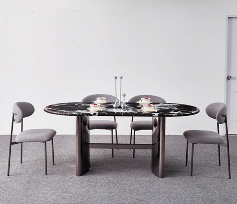Black marble oval dining table with sleek dark metal legs and modern minimalist design meroy dining table