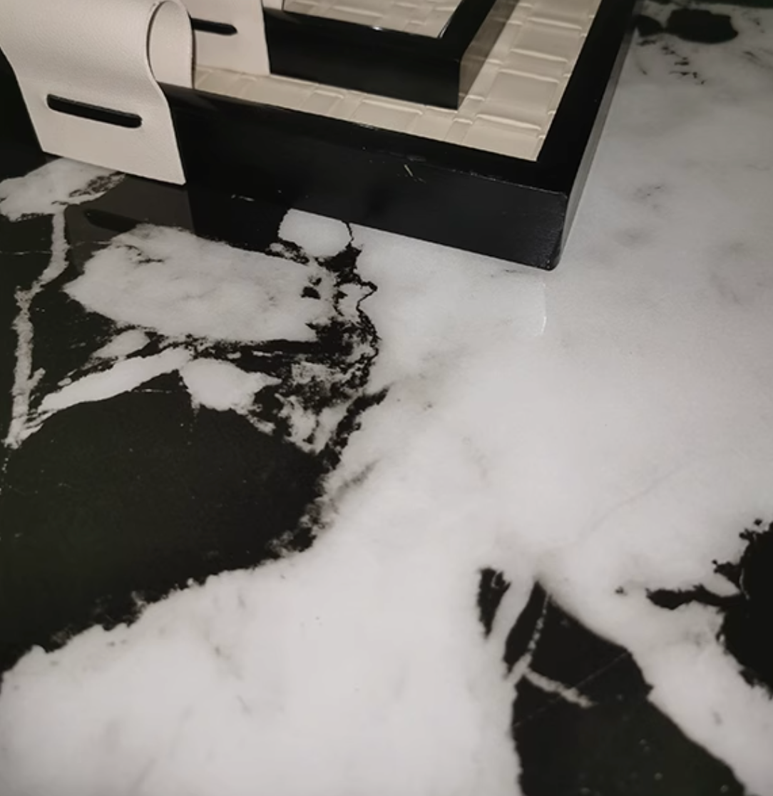 Black and white marble countertop with glossy finish on the meroy dining table for a stylish dining setup