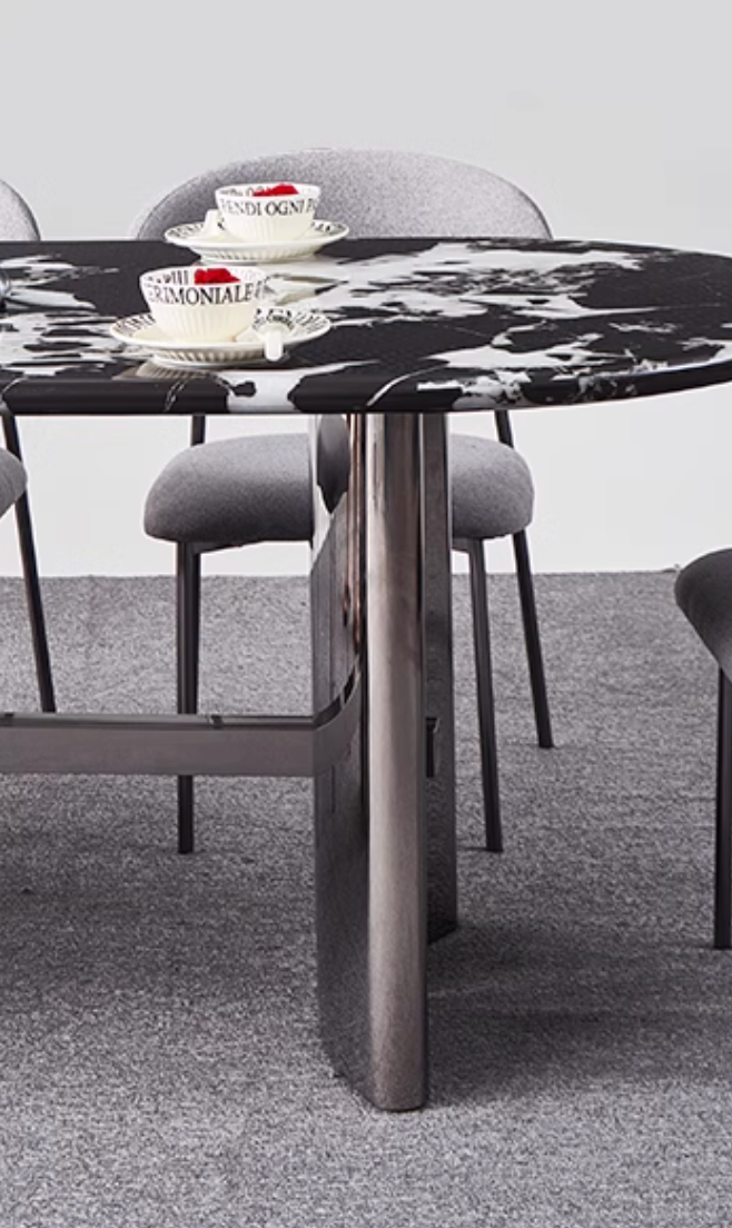 Black and white marble meroy dining table with sleek metallic legs perfect for modern dining spaces