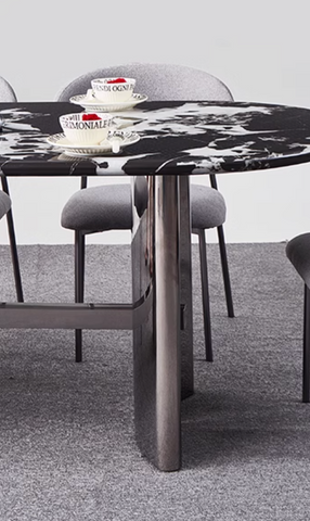 Black and white marble meroy dining table with sleek metallic legs perfect for modern dining spaces