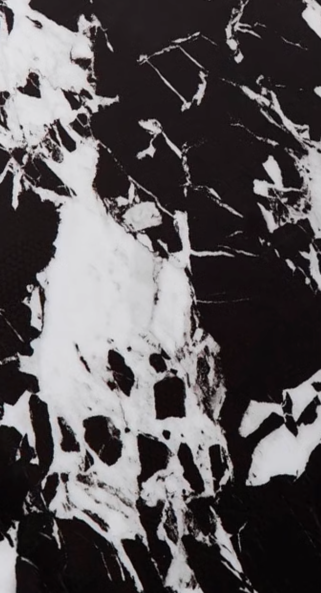 Black and white marble surface with swirling patterns on the meroy dining table marble top