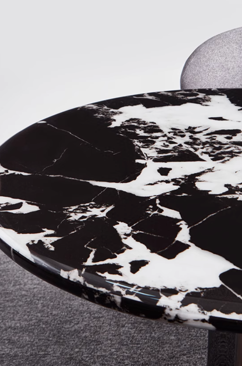 Black and white marble tabletop with sleek polished finish on meroy dining table perfect for dining spaces
