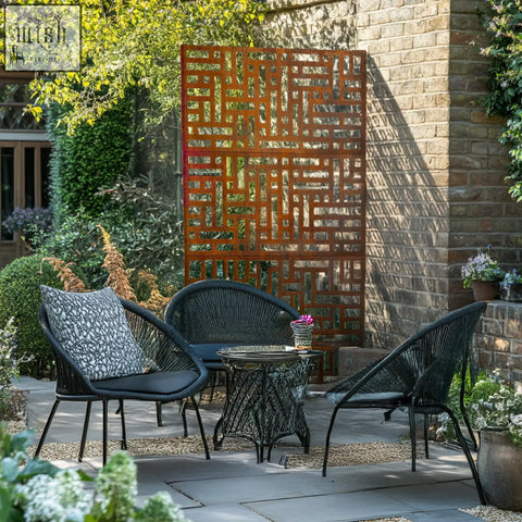 Black wicker patio set with rust-colored metal privacy screen featuring geometric maze pattern for indoor outdoor use