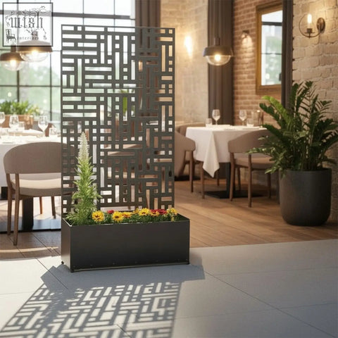 Black metal indoor outdoor privacy screen planter with rectangular base and lattice design holding greenery and flowers