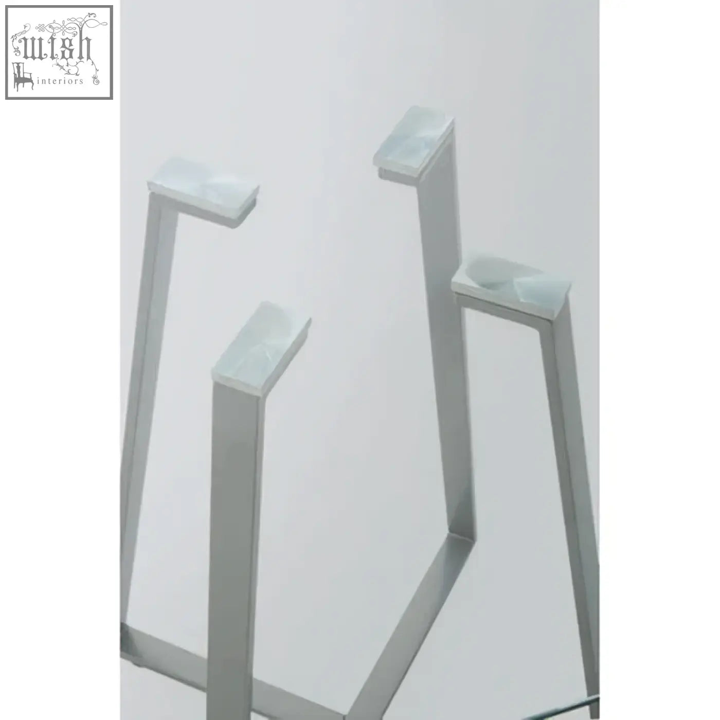 Silver metal table legs of a sleek modern metropolitan square matte grey dining table with a square matte grey finish