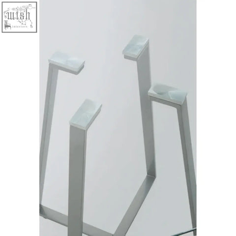 Silver metal table legs of a sleek modern metropolitan square matte grey dining table with a square matte grey finish