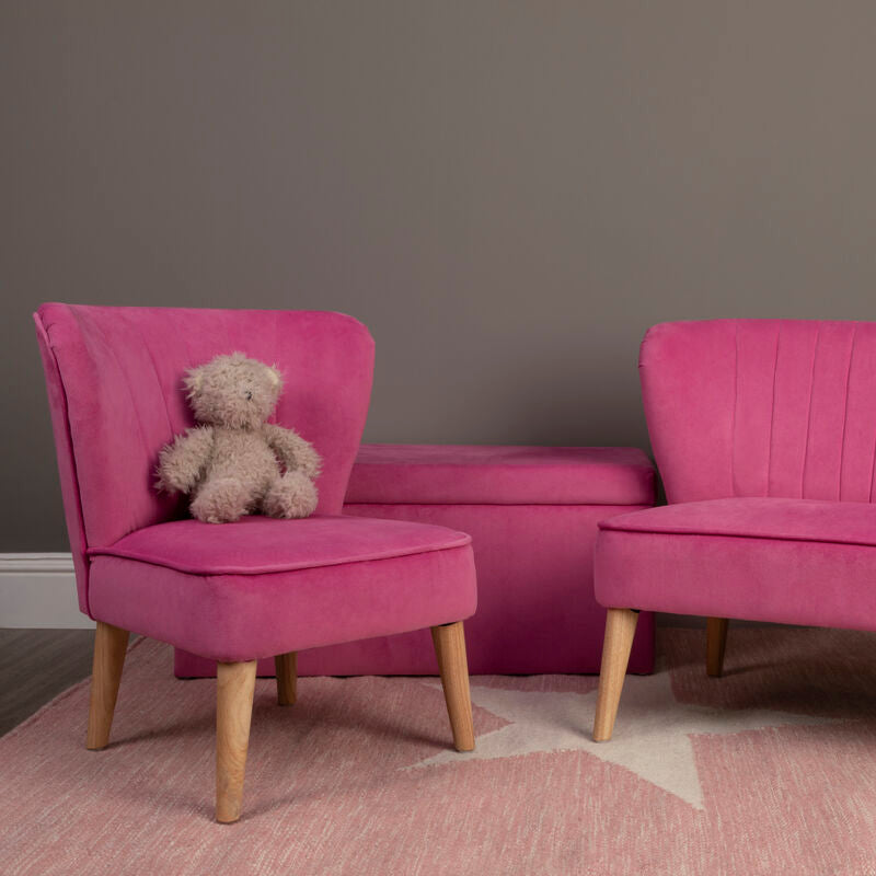 Vibrant pink velvet kids ottoman with light wood legs and tufted backrest from the mia pink velvet collection