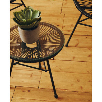 Black rattan round wrought iron table with radial woven design and glass top in miami black rattan patio set