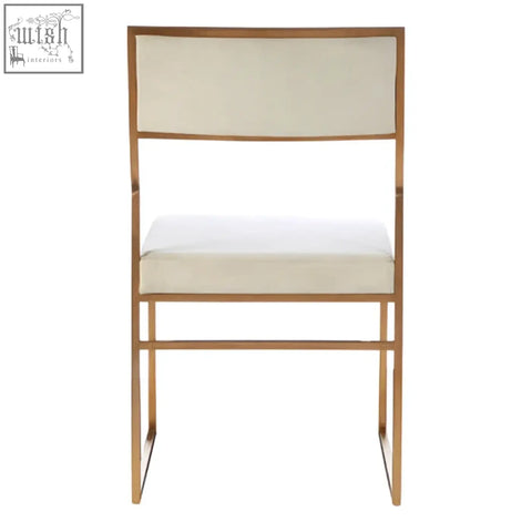 Gold-toned metal frame dining chair with milky white velvet upholstered seat and back for a stylish look