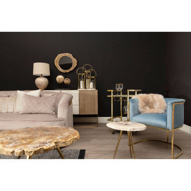Mias blue velvet chair with gold metal frame and fluffy beige throw pillow for cozy seating style