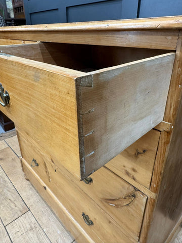 Mid victorian rustic pine chest of drawers with rounded corners light wood dovetail joints and dark metal handles