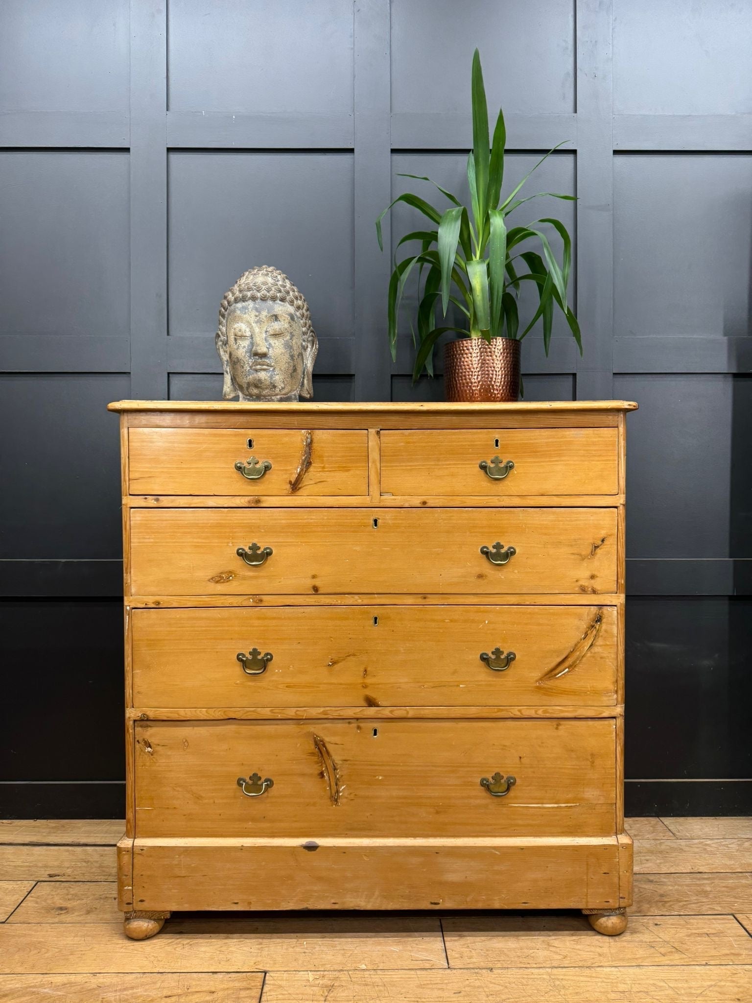 Light-colored pine chest with rounded corners and brass handles showing visible wood grain for farmhouse storage