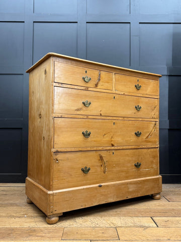 Light-colored pine chest of drawers with four drawers and rounded corners for antique farmhouse bedroom storage