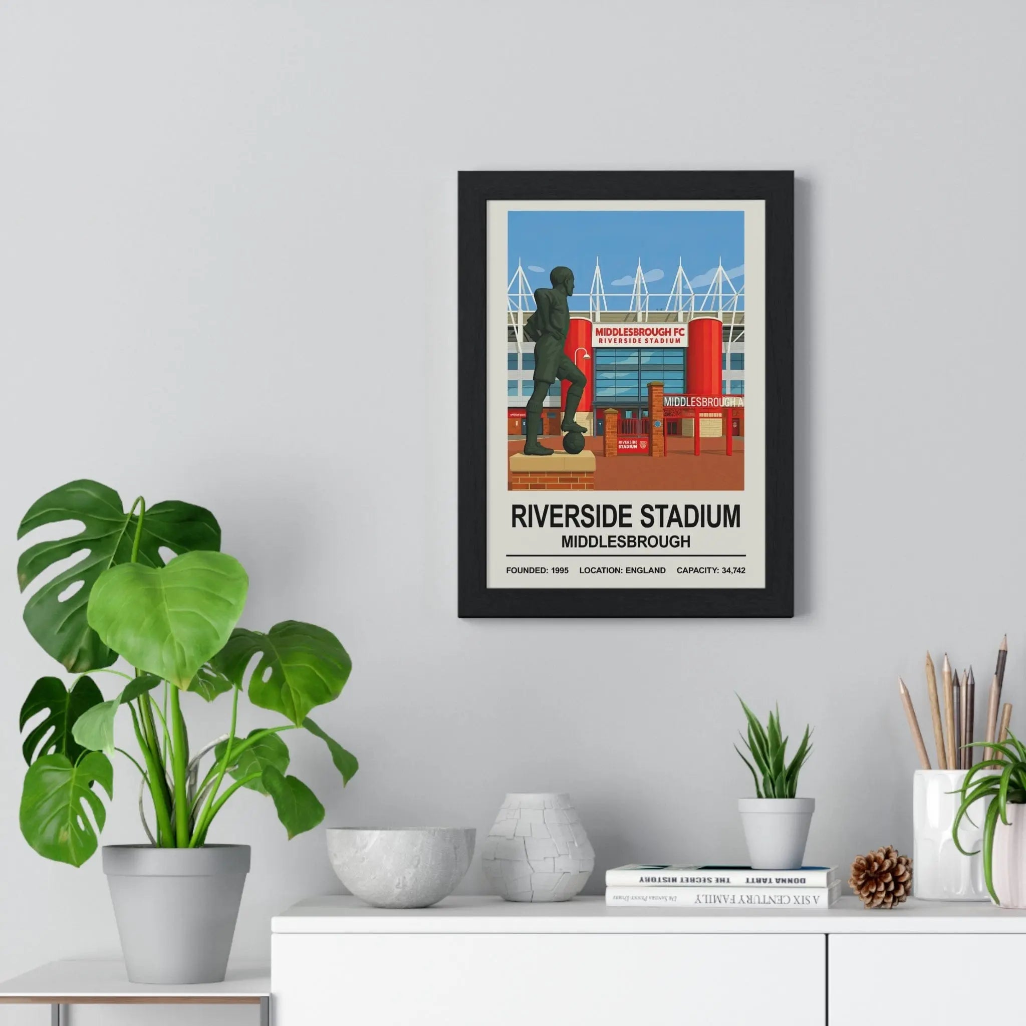 Black-framed middlesbrough riverside stadium print with red and blue stylized illustration of FC stadium