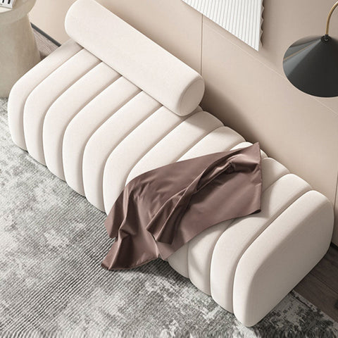 Cream-colored ribbed velvet mignon bread bench with matching cylindrical pillow and brown satin cloth on top