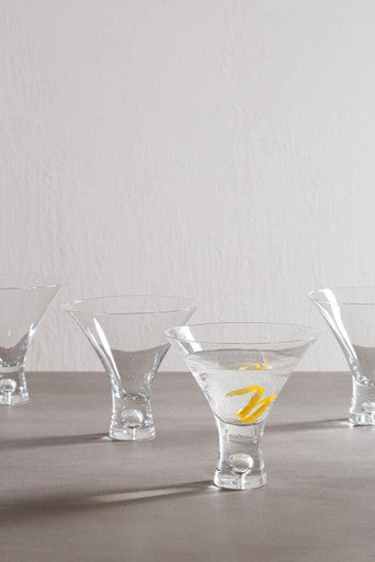 Mila set of 2 clear cocktail glasses 330ml with distinctive stems one glass contains ice and yellow citrus twists