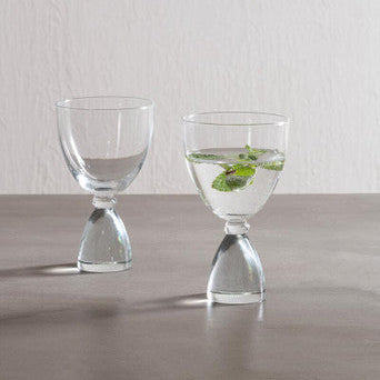 Mila set of 2 clear cocktail glasses with hourglass base and delicate stems filled with fresh mint leaves